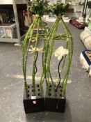 A PAIR OF BAMBOO STEM ARRANGEMENTS, EACH ABOUT A CENTRAL ORCHID FLOWER