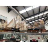 TEN WOODEN MODEL BOATS, ALL BUT A TUG IN FULL SAIL