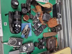 A COLLECTION OF STILL AND MOVIE CAMERAS, LENSES, VIEWERS, CARRYING BAGS, ETC.