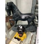 A CAST IRON MONEY BOX AND A LARGE HORSE FIGURE.