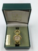 A LADIES VINTAGE GUCCI BANGLE WATCH WITH MOTHER OF PEARL DIAL, REFERENCE 1900, COMPLETE WITH BOX AND