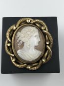 A VICTORIAN PORTRAIT CAMEO REVERSIBLE BROOCH WITH GLAZED BACK ENCLOSING HAIR. MEASUREMENTS H 6.0 X W