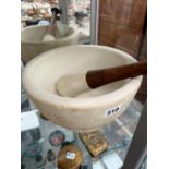 A LARGE PESTLE AND MORTAR.