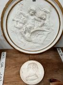 A PLASTER ROUNDEL OF CHARLOTTE BRONTE TOGETHER WITH ANOTHER OF THREE PUTTI RIDING AN EAGLE