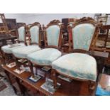 A SET OF FOUR 19th C. WALNUT SALON CHAIRS, WITH INDIVIDUAL CARVED UPPER CREST RAILS