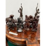 FOUR CHINESE CARVED WOOD FIGURES, ANOTHER IN SOAPSTONE, A PAIR OF SPELTER FIGURES AND AN IRON BEAR.