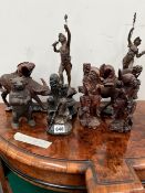 FOUR CHINESE CARVED WOOD FIGURES, ANOTHER IN SOAPSTONE, A PAIR OF SPELTER FIGURES AND AN IRON BEAR.