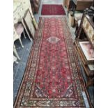 AN EASTERN RUNNER AND A SMALL BELOUCH RUG