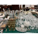 A CUT GLASS DRINKING SET, OTHER DRINKING GLASS, DECANTERS, CANDELABRA, TABLE AND OIL LAMPS,