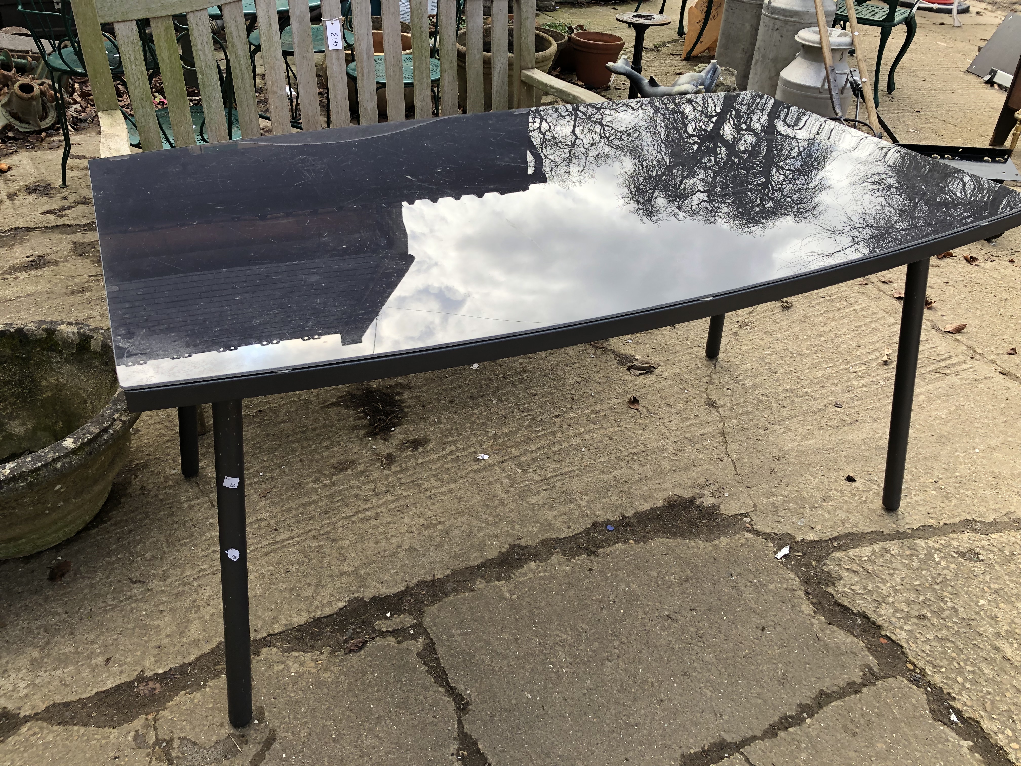 A GLASS TOP PATIO TABLE WITH A SET OF FIVE STACKING ROPE SEAT CHAIRS