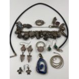 AN ASSORTMENT OF SILVER JEWELLERY TO INCLUDE A CHARM BRACELET AND VARIOUS CHARMS, ATTACHED ARE: A