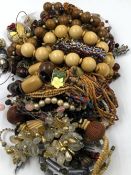 A LARGE MIXED BAG OF VARIOUS COSTUME JEWELLERY TO INCLUDE BEADED NECKLACES, BRACELETS, BROOCHES,