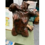 A BROWN GLAZED PLASTER TORSO OF A LADY