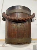 A VINTAGE TEAK AND BRASS BOUND BUCKET WITH MAKERS TAG, MADE FROM TIMBERS OF BATTLE SHIPS. CIRCA