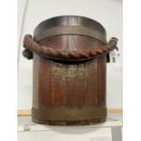 A VINTAGE TEAK AND BRASS BOUND BUCKET WITH MAKERS TAG, MADE FROM TIMBERS OF BATTLE SHIPS. CIRCA