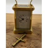 A GARRARD & CO SMALL CARRIAGE CLOCK WITH BALANCE WHEEL ESCAPEMENT COMPLETE WITH KEY.