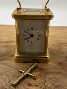 A GARRARD & CO SMALL CARRIAGE CLOCK WITH BALANCE WHEEL ESCAPEMENT COMPLETE WITH KEY.