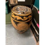 A CHINESE BROWN POTTERY BARREL GARDEN SEAT DECORATED WITH AN OCHRE DRAGON