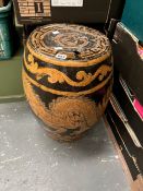 A CHINESE BROWN POTTERY BARREL GARDEN SEAT DECORATED WITH AN OCHRE DRAGON