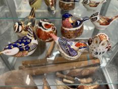 A GROUP OF SEVEN ROYAL CROWN DERBY SMALL PAPERWEIGHT BIRD FIGURES.