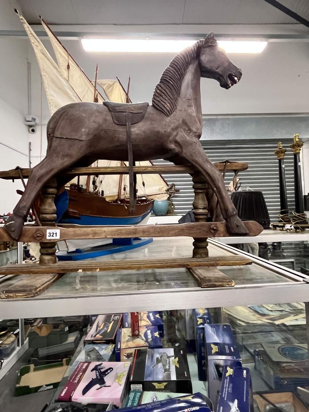 A VINTAGE INFANT SIZED WOODEN ROCKING HORSE.