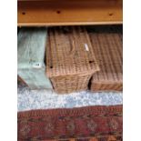 A RUSTIC STOOL AND TWO WHICKER HAMPERS