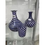 THREE BLUE AND WHITE SPIRAL GLASS VASES.
