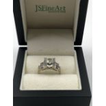 A 14K STAMPED ART DECO STYLE RING SET WITH CUBIC ZIRCONIAS, ASSESSED AS 14ct WHITE GOLD. WEIGHT 5.