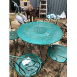 A GREEN PAINTED WROUGHT IRON PATIO TABLE AND FOUR CHAIRS
