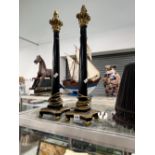 A PAIR OF EBONISED CORINTHIAN COLUMN TABLE LAMPS.