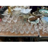 A SELECTION OF DRINKING GLASS, KITCHEN SCALES AND WEIGHTS, CASED SUGAR TONGS AND PLATES TO INCLUDE