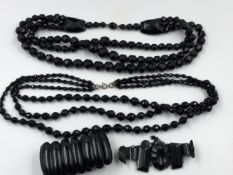 A COLLECTION OF BLACK FACET MOURNING TYPE JEWELLERY TO INCLUDE A TWO THREE STRAND WATERFALL