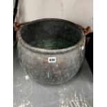 A COPPER CAULDRON OVERSWUNG BY AN IRON HANDLE