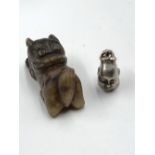AN ORIENTAL 970 GRADE SILVER BUST CHARM TOGETHER WITH A CARVED HARDSTONEFOOP DOG. SILVER WEIGHT