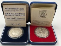 TWO ELIZABETH II SILVER CROWN COINS IN CAPSULES, DATED 1977 AND 1981.