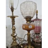 A CRANBERRY GLASS OVERLAY TABLE LAMP, A BRASS TABLE LAMP AND AN OIL LAMP
