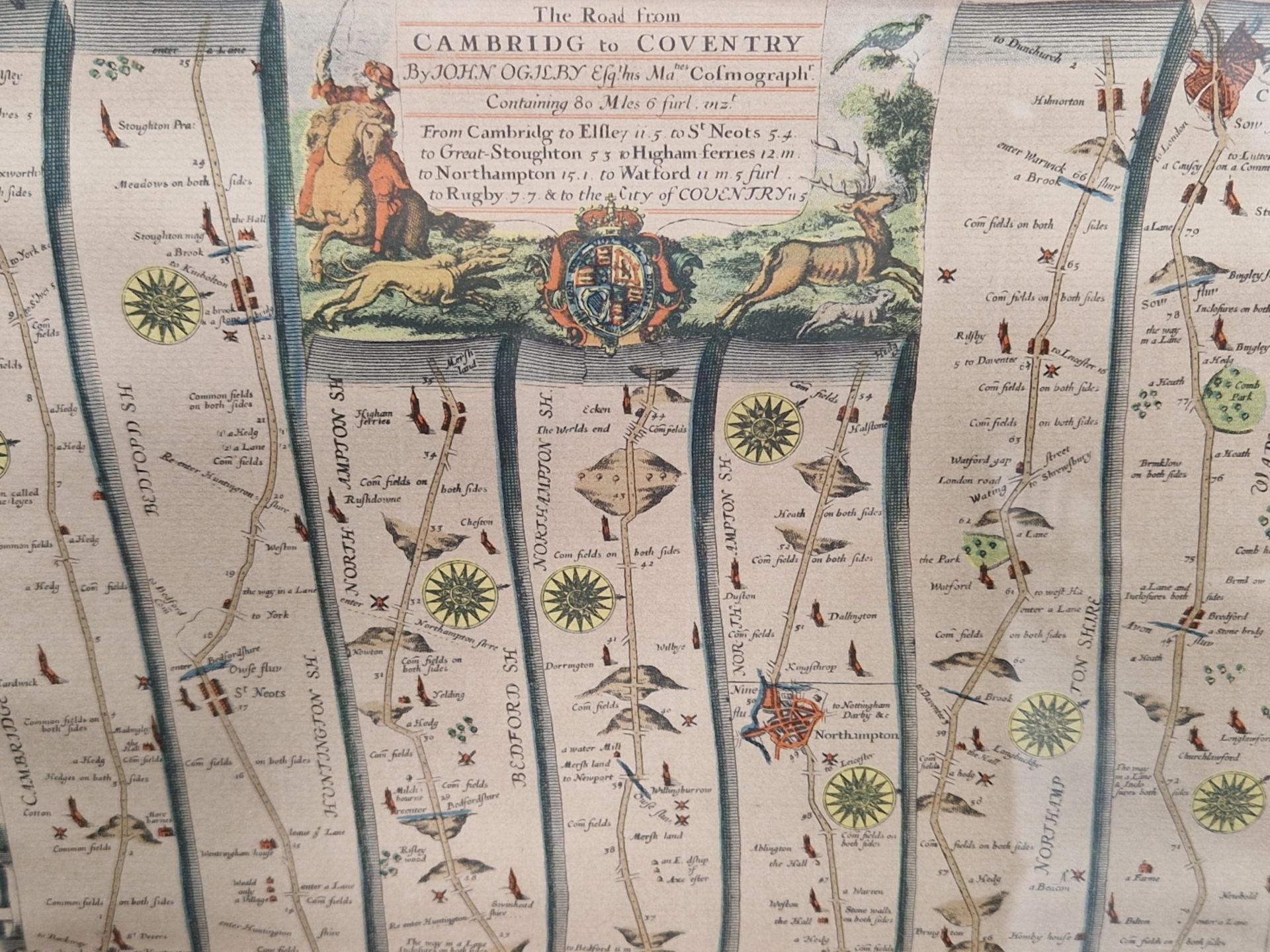 AN ANTIQUE HAND COLOURED STRIP MAP AFTER JOHN OGILBY, THE ROAD FROM CAMBRIDGE TO COVENTRY.