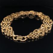 A HEAVY, FANCY GATE LINK BRACELET. THE CLASP STAMPED INDISTINCTLY. ASSESSED AS 18ct GOLD. WIDTH 1.