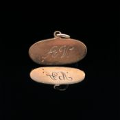A OVAL INGOT ENGRAVED A.V TO THE FRONT AND WITH ALL MY LOVE KIMMY TO THE REVERSE. STAMPED 9ct,