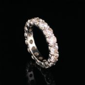 A DIAMOND FULL ETERNITY RING. THE BAND SET WITH 17 ROUND BRILLIANT CUT DIAMONDS, APPROXIMATELY 4mm