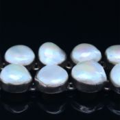 A SILVER AND PEARL TWO ROW BRACELET. THE BRACELET WITH TWO ROWS OF 10 PEARLS IN INDIVIDUAL RUB