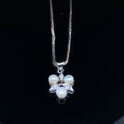 A DIAMOND AND PEARL PENDANT. THREE PEARLS AND THREE DIAMONDS EVENLY SET, SUSPENDED ON AN S LINK