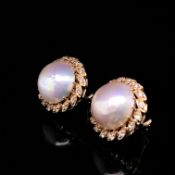 A PAIR OF MABE PEARL AND DIAMOND EARRINGS WITH LEVER BACK SAFETY PIERCED EAR FITTINGS. EACH MABE