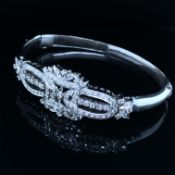 A MULTI DIAMOND ART DECO STYLE HINGED BANGLE. THE BANGLE UNMARKED, BUT ENGRAVED 1-96 NEXT TO THE