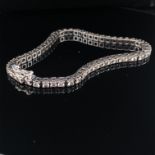 A DIAMOND TENNIS BRACELET. THE BRACELET CONSISTING OF 55 ROUND BRILLIANT CUT DIAMONDS, EACH