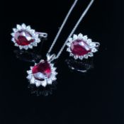 A PAIR OF RUBY AND DIAMOND EARRINGS AND A MATCHING PENDANT WITH CHAIN. THE EARRINGS STAMPED ZEN 14K,