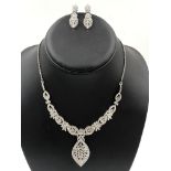 AN IMPRESSIVE MULTI DIAMOND NECKLACE AND EARRING SUITE. THE NECKLACE WITH GRADUATING DIAMOND