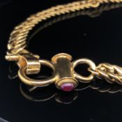 A FLAT CLOSE CURB NECK CHAIN. THE FEATURE CLASP SET EITHER SIDE WITH A CABOCHON RUBY AND SAPPHIRE