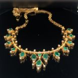 AN EMERALD AND DIAMOND NECKLACE. THE NECKLACE SET WITH 14 OVAL CUT GRADUATING EMERALDS AND ONE ROUND