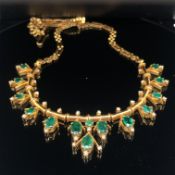 AN EMERALD AND DIAMOND NECKLACE. THE NECKLACE SET WITH 14 OVAL CUT GRADUATING EMERALDS AND ONE ROUND